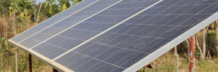 Close up outdoor view of solar panels located in a rural garden in Benin in order to supply energy for a pumping system. African agricultural picture of a traditional technology.
